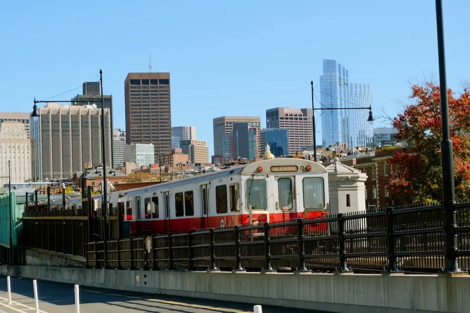 Boston Red Line train with skyline in background.